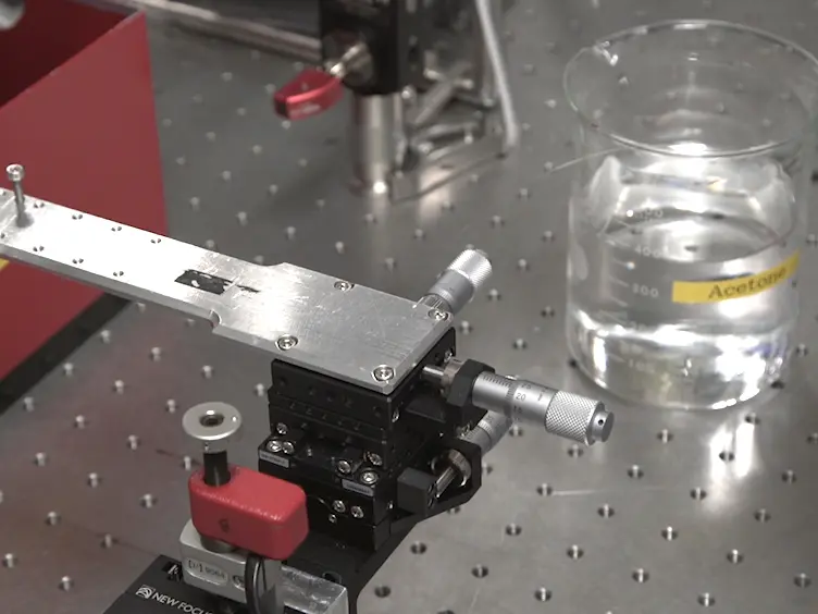 Fabrication of 1-D Photonic Crystal Cavity on a Nanofiber Using Femtosecond Laser-induced Ablation