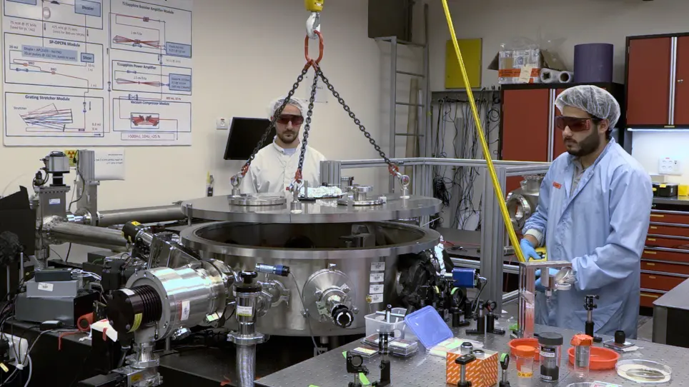 Automated Delivery of Microfabricated Targets for Intense Laser Irradiation Experiments
