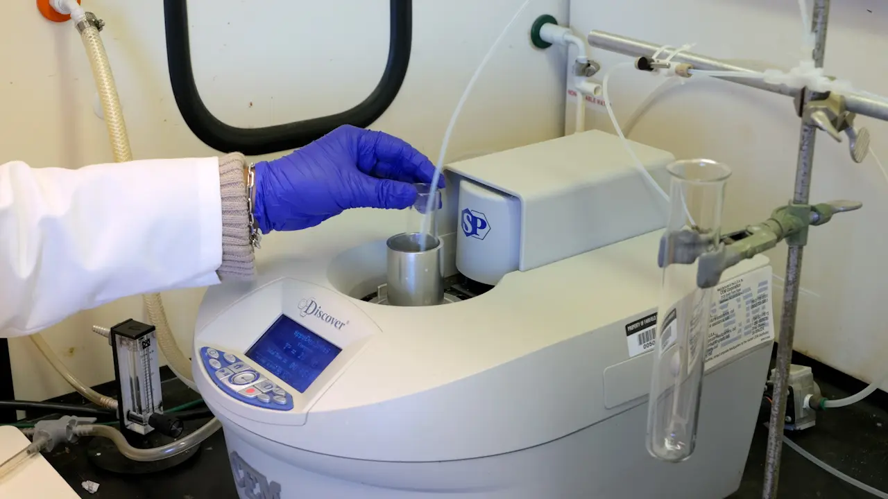 An Inexpensive Adaptation of a Commercial Microwave Reactor for Solid Phase Peptide Synthesis