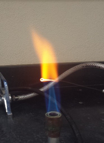 Bunsen burner flame test, spectroscopy experiment for optical emission analysis in a lab setup.
