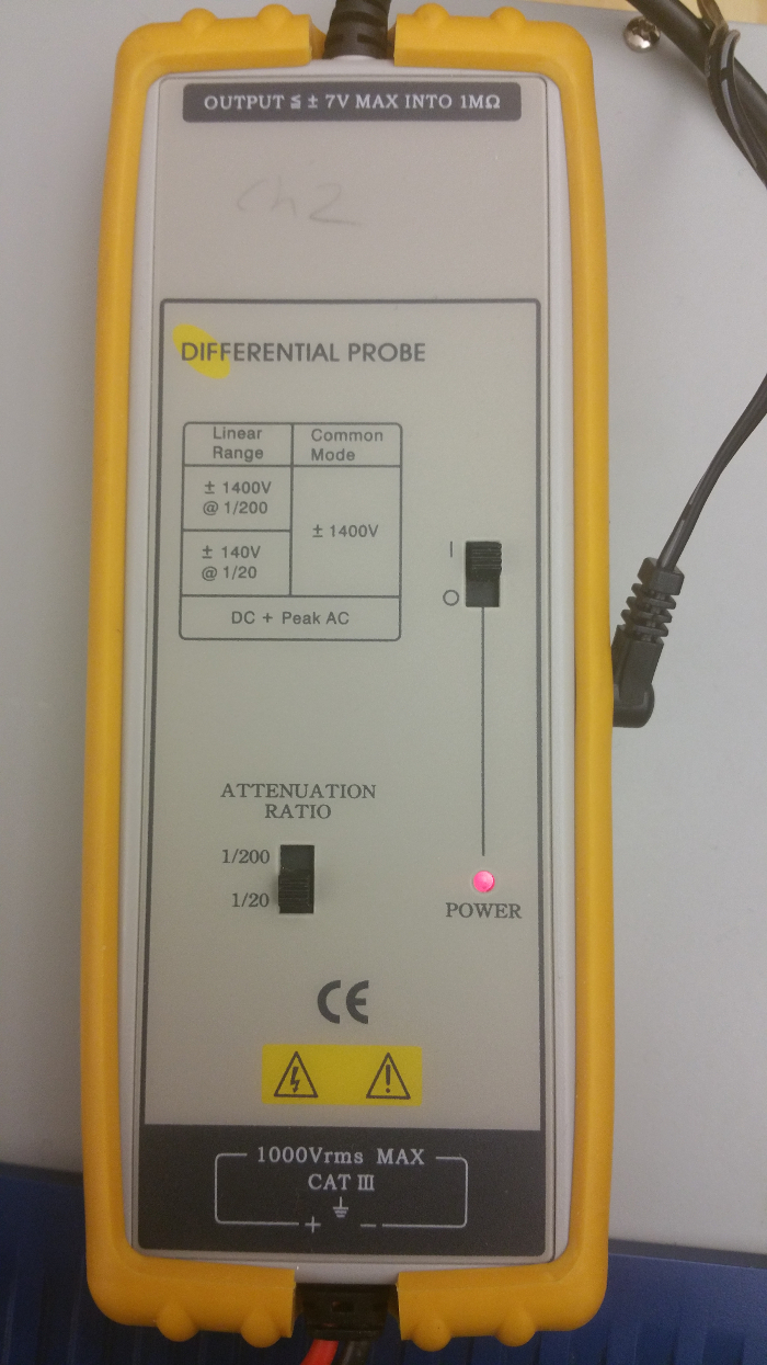 Differential probe equipment for voltage measurement, showing settings and warning labels.