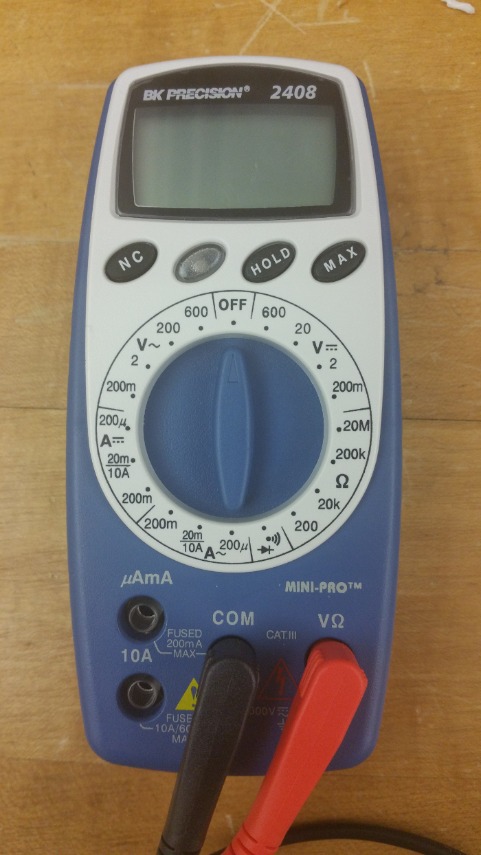 Digital multimeter measurement setup; voltage, current, resistance testing instrument; electronic analysis.