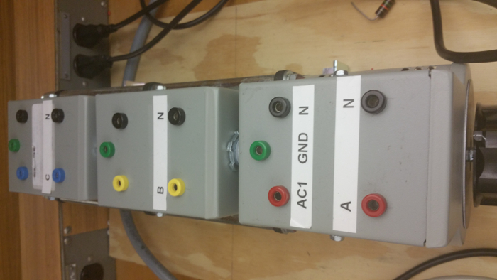 Electrical circuit connection panel for power distribution system setup; labeled for input/output.