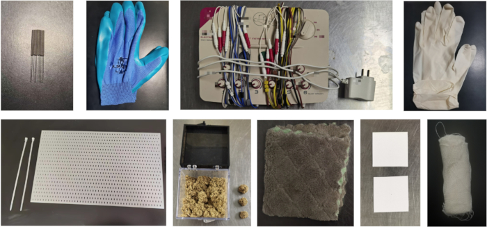 Research equipment setup featuring electrical wires, gloves, and materials for a scientific experiment.