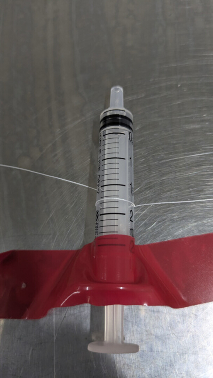 figure-protocol-2 Syringe setup for fluid measurement in static equilibrium experiment; laboratory equipment.