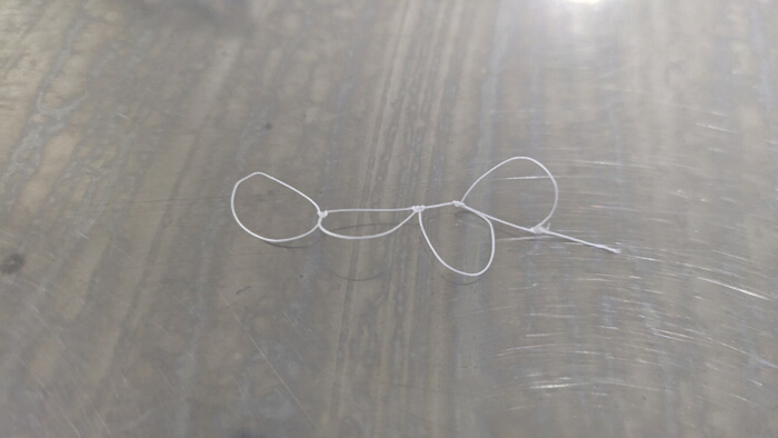 figure-protocol-4 String knot on a table; illustrates knot theory concept used in mathematical study and analysis.